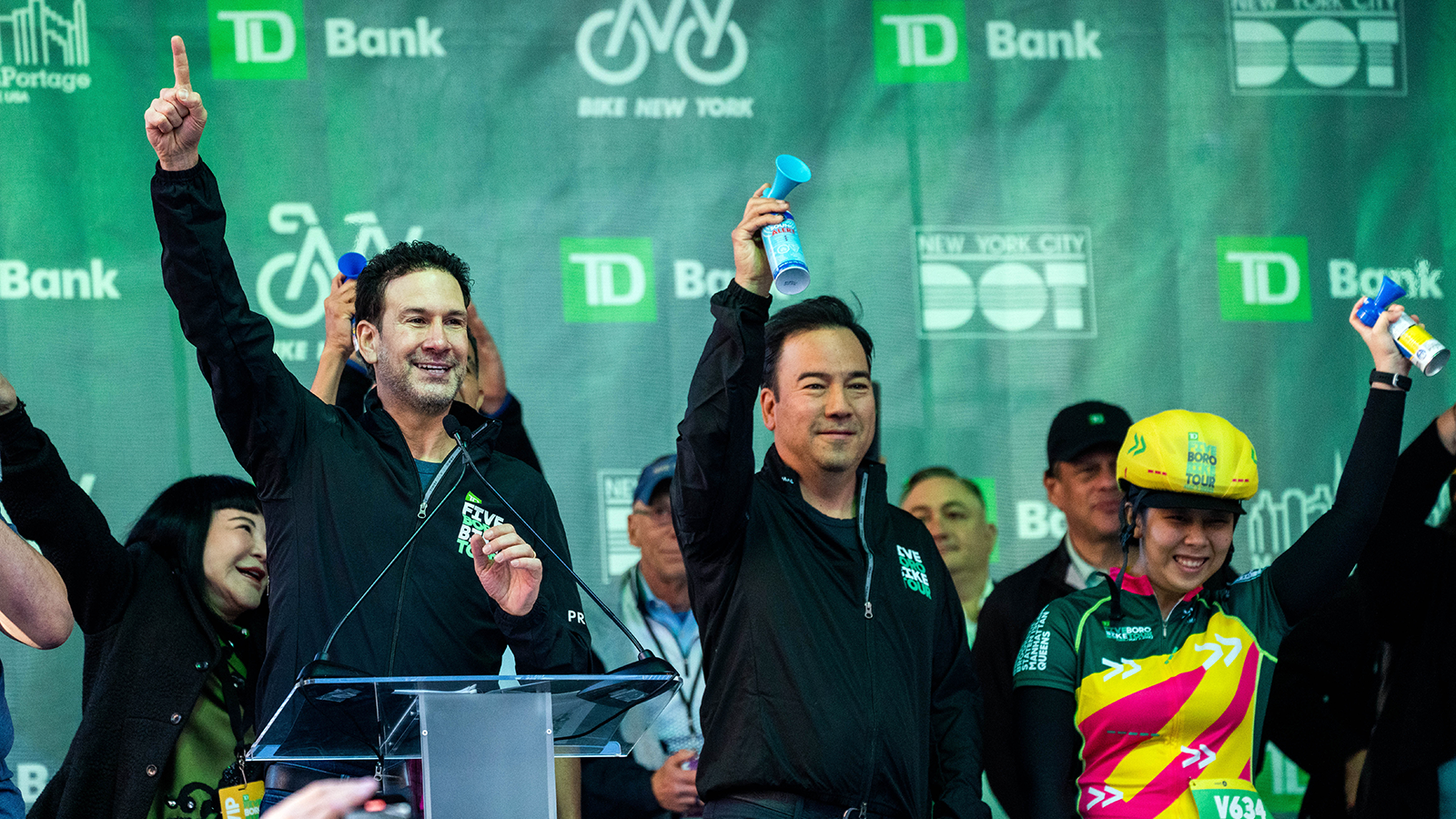 TD colleagues blowing an airhorn to start the Five Boro Bike Tour