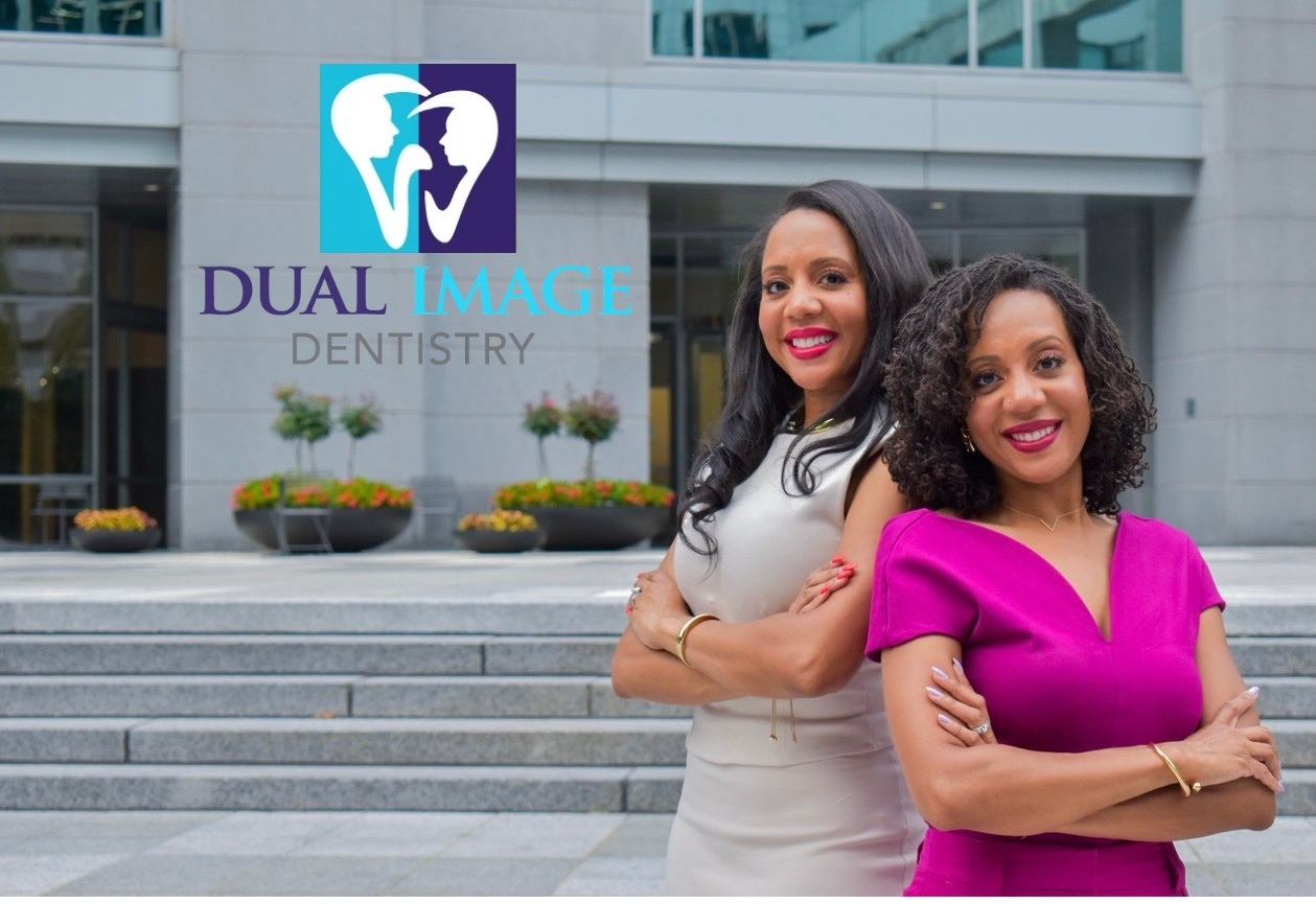 Two woman in front of a building that says