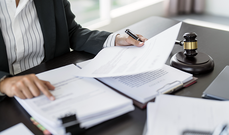 close up of a woman looking through legal documents