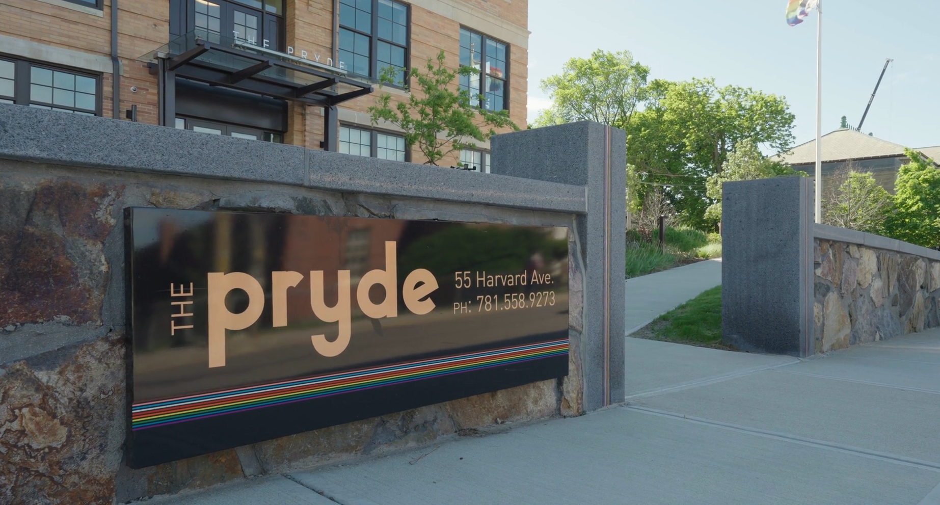 The Pryde sign in front of apartment building