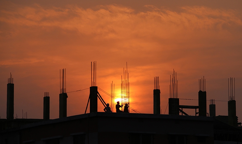 Construction workers in silhouette