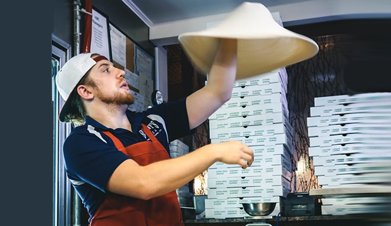 man making pizza