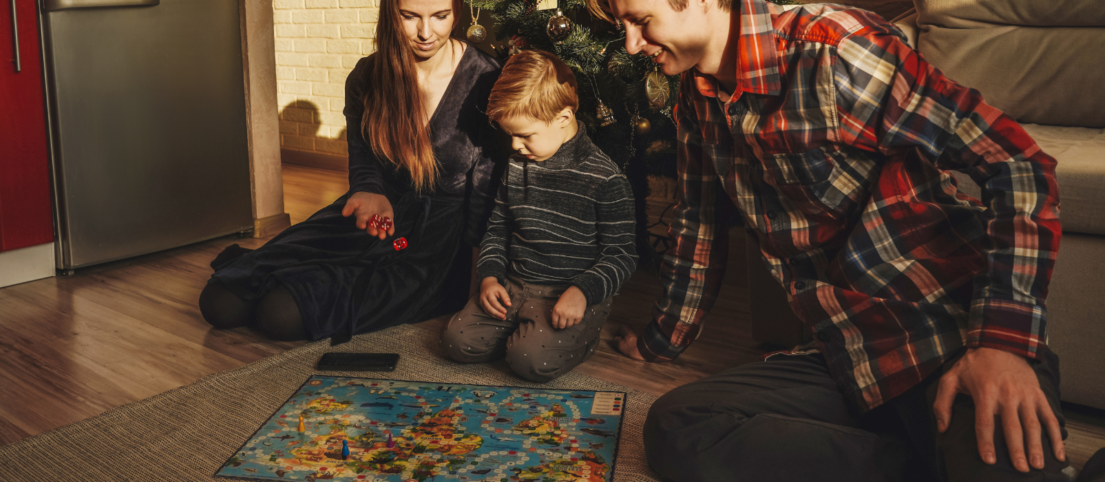 Man and woman doing a puzzle with a young boy on the floor