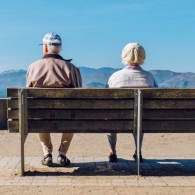 Elderly couple sitting together on a bench