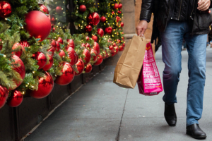Man with shopping bags with Christmas decorations