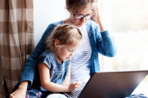 Mother working from home with daughter