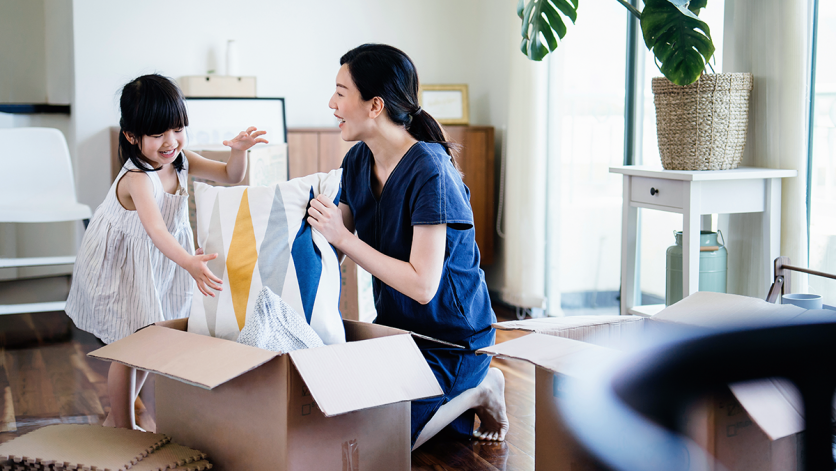 mother and daughter unpacking boxes