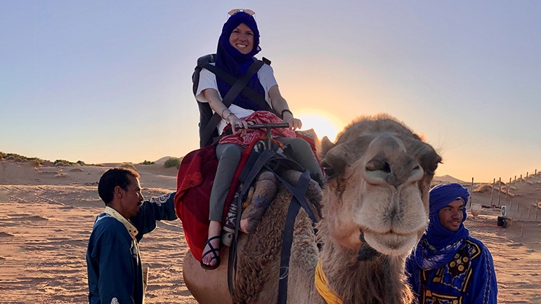 Caitlin Messick on a camel in Morocco