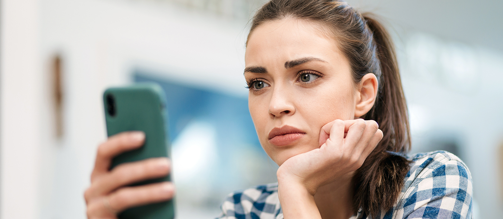 stressed out woman looking at her cell phone