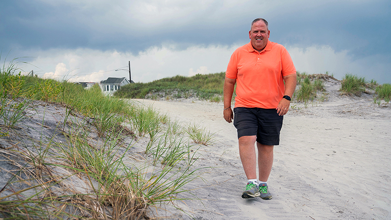 Jeff Keller walking on a beach