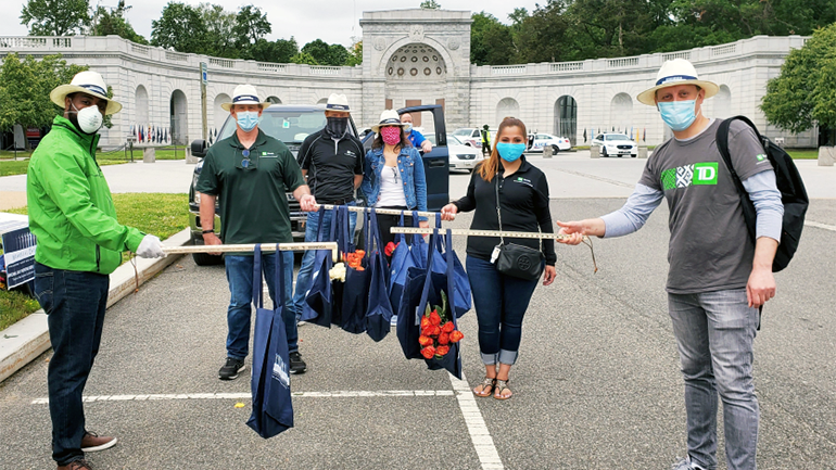 group of TD colleagues with flowers at the Arlington cemetery