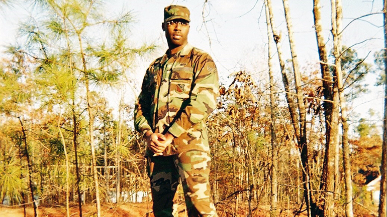 Victor in a background of a forest in his military uniform