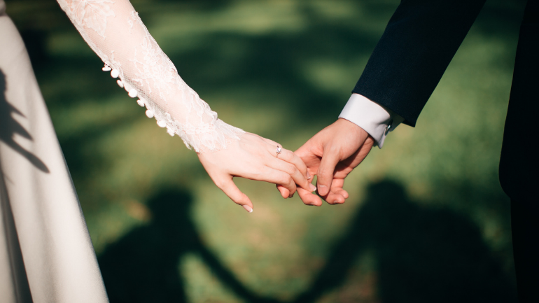 Bridge and groom close up shot of them holding hands