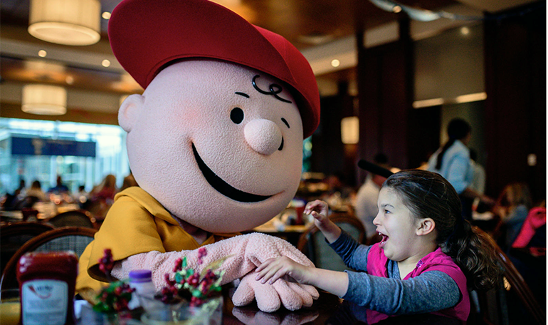 young girl with mascot at a resort