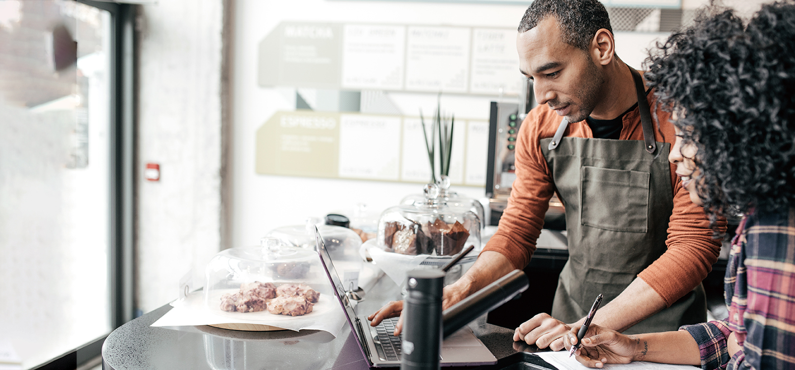 Cafe owner working on a laptop