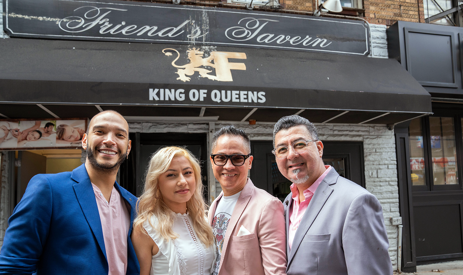 A group of people (3 men, 1 woman) in front of Friend's Tavern in NY