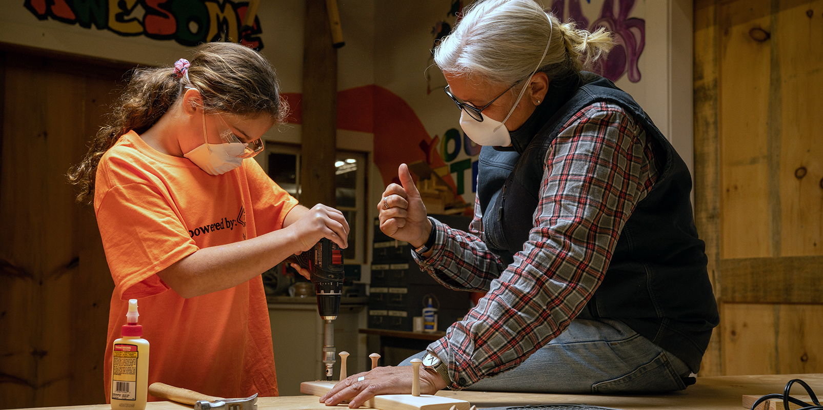 Xiomara working with a young girl on a project