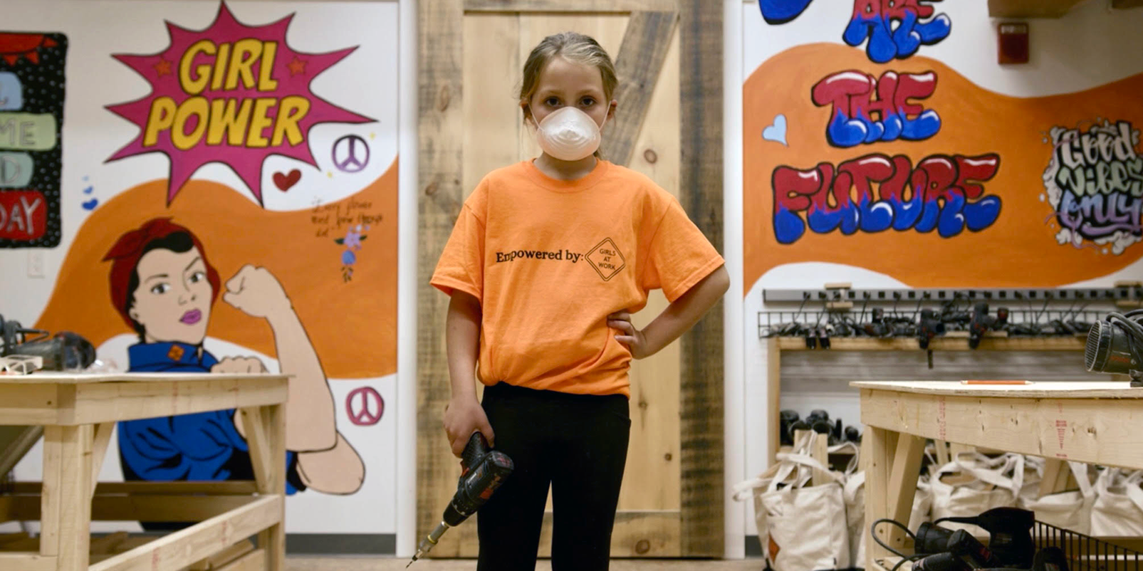 Young girl holding a drill