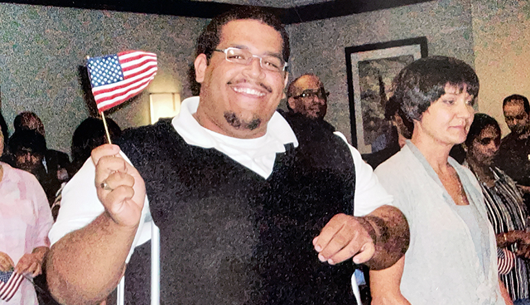 Cesar Barral-Rujano holding a small American flag