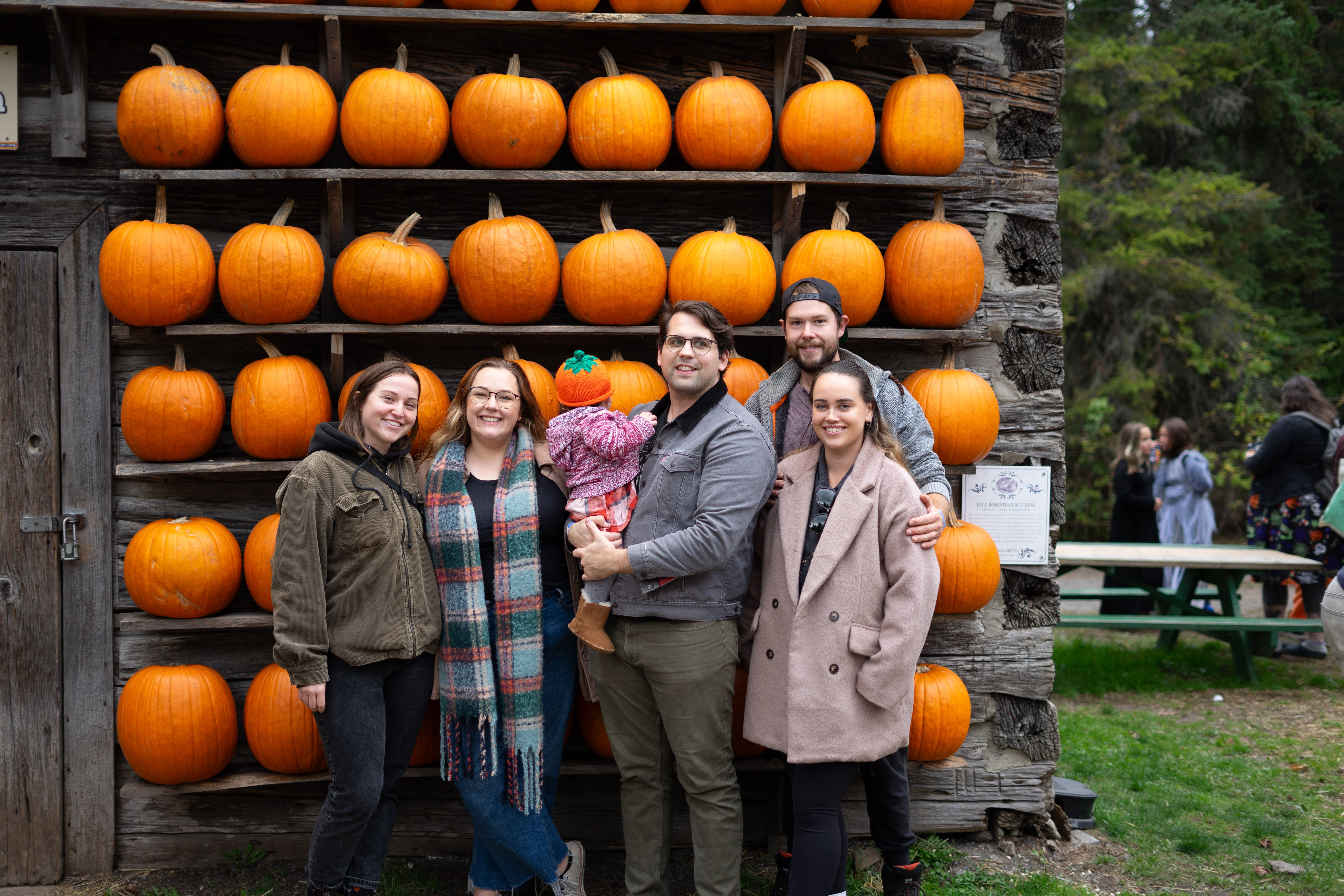 Family photo in front of pumpkins