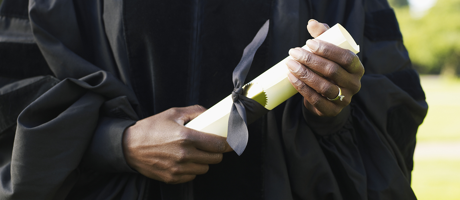 Close up of hands holding a diploma