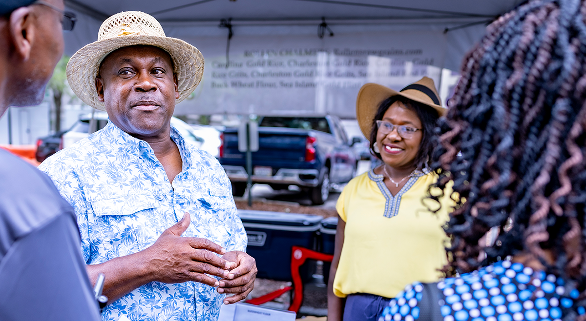 Rollen and his wife, Frances, speaking to customers