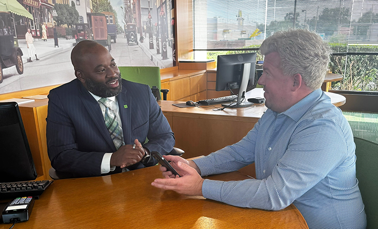 Malcolm Davis, TD Bank Store Manager in Williamstown, New Jersey, assisting a customer.