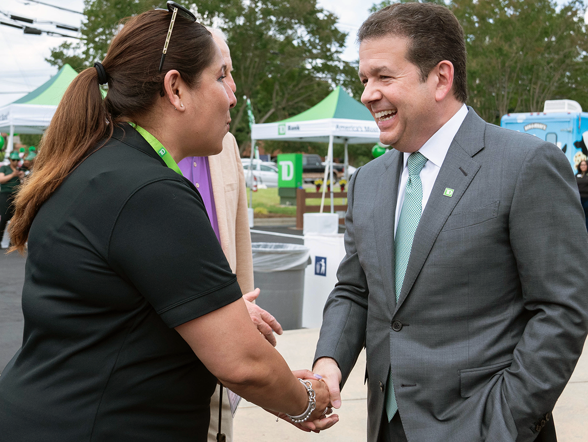 Leo Salom, CEO, shakes the hand of a TD colleague