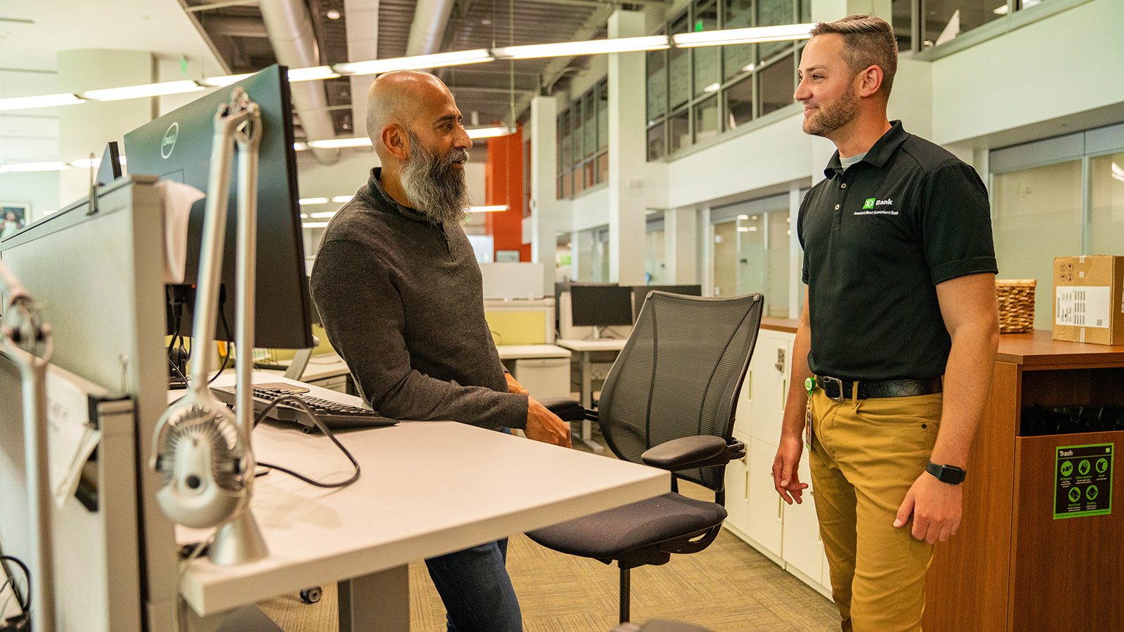 Ravi in the office talking to a TD colleague