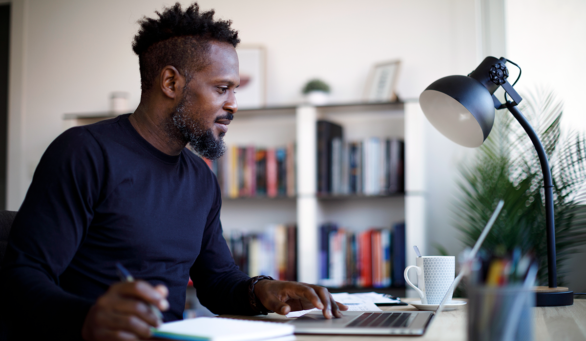Man on laptop siting at a desk