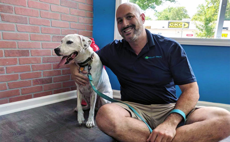 Steve Garibell at his Doggy Daycare business with a dog