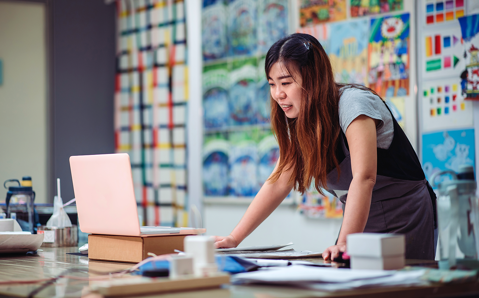 Woman in a classroom looking at a laptop
