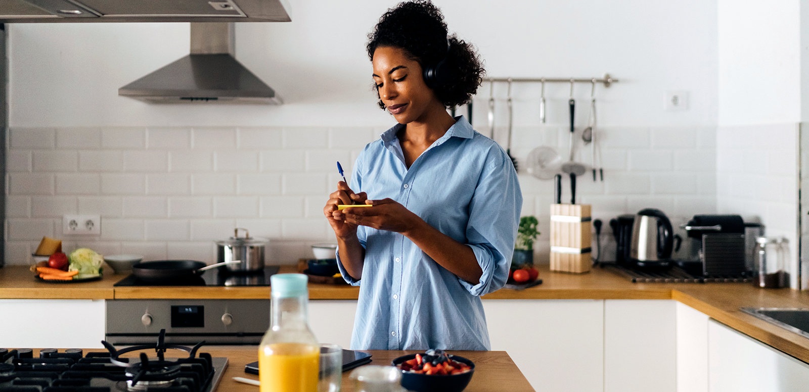 woman making a list in her kitchen