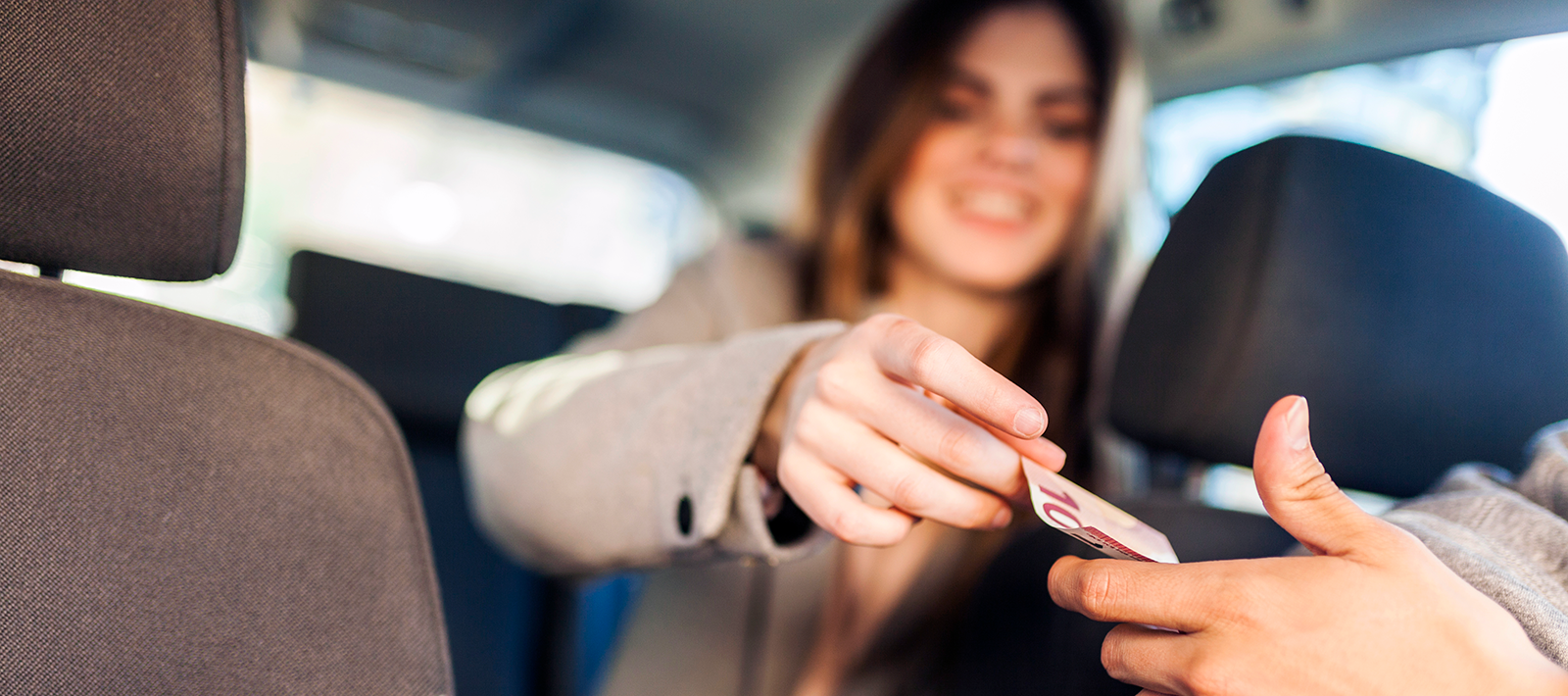 woman handing euro to a driver